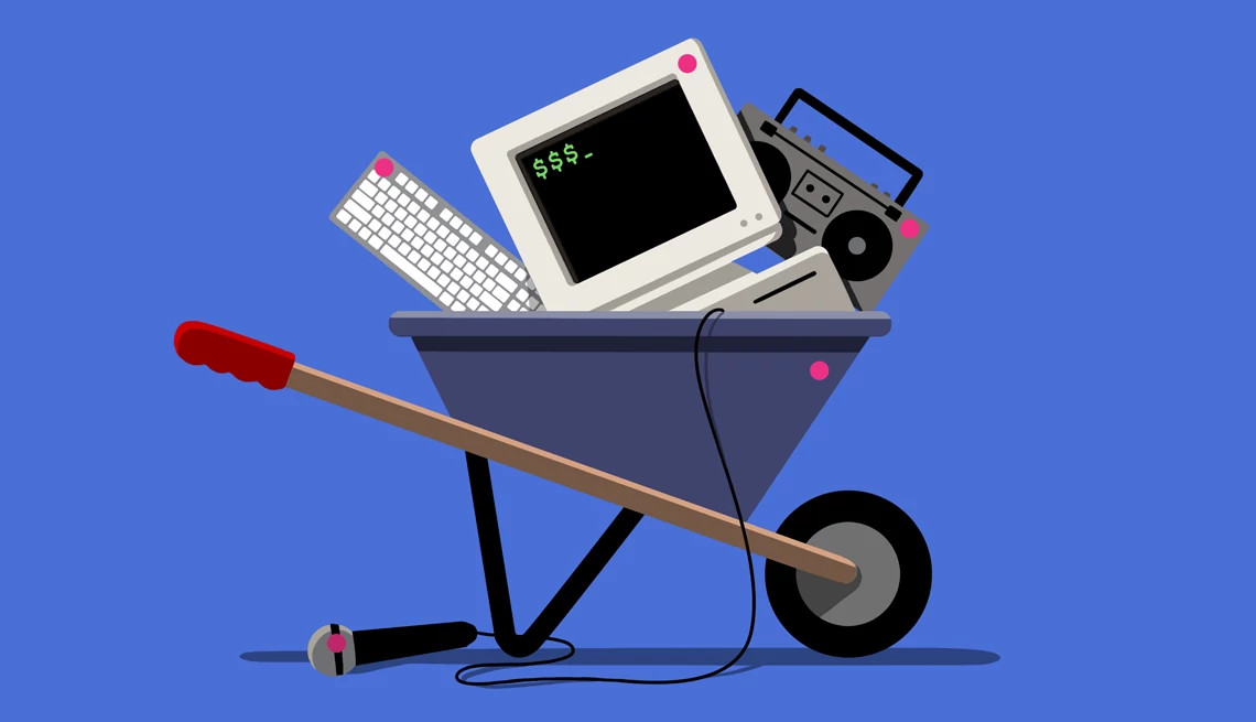 old electronics are stacked in a wheelbarrow