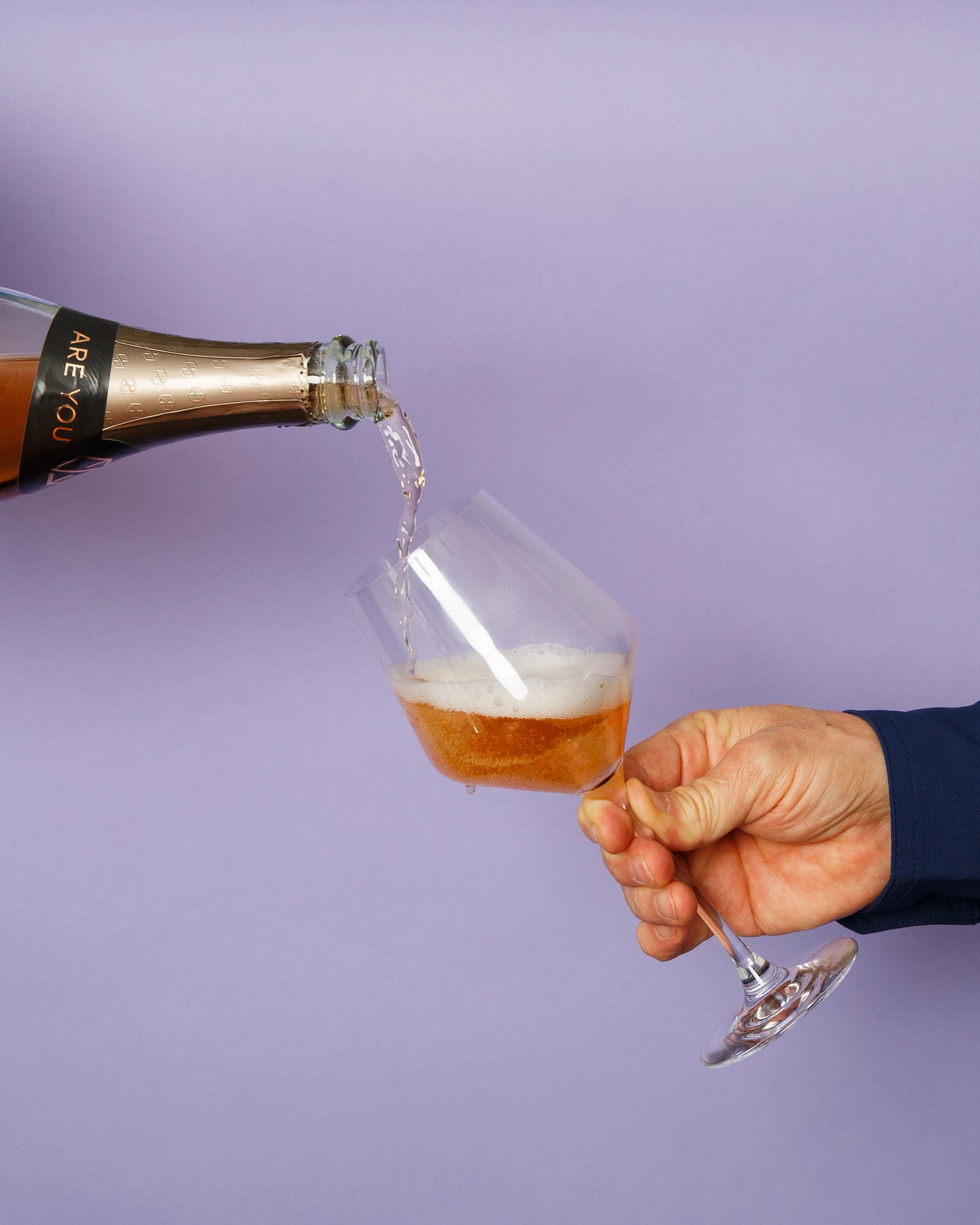 a photo shows a nonalcoholic rose being poured into a champagne glass