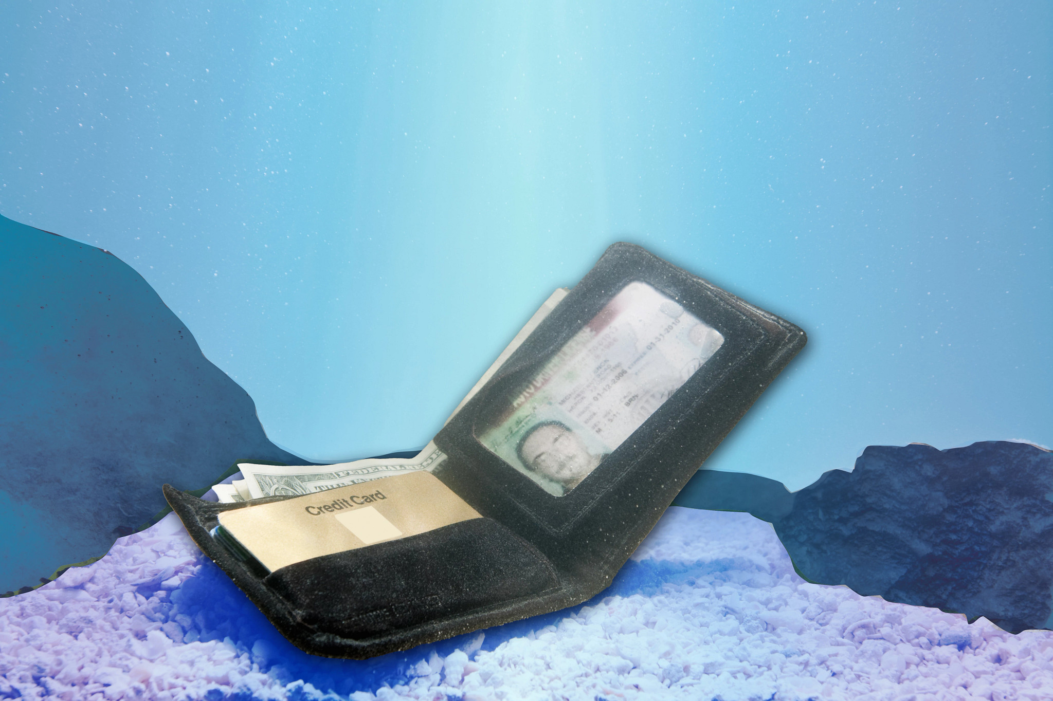 a wallet sits at the bottom of the ocean