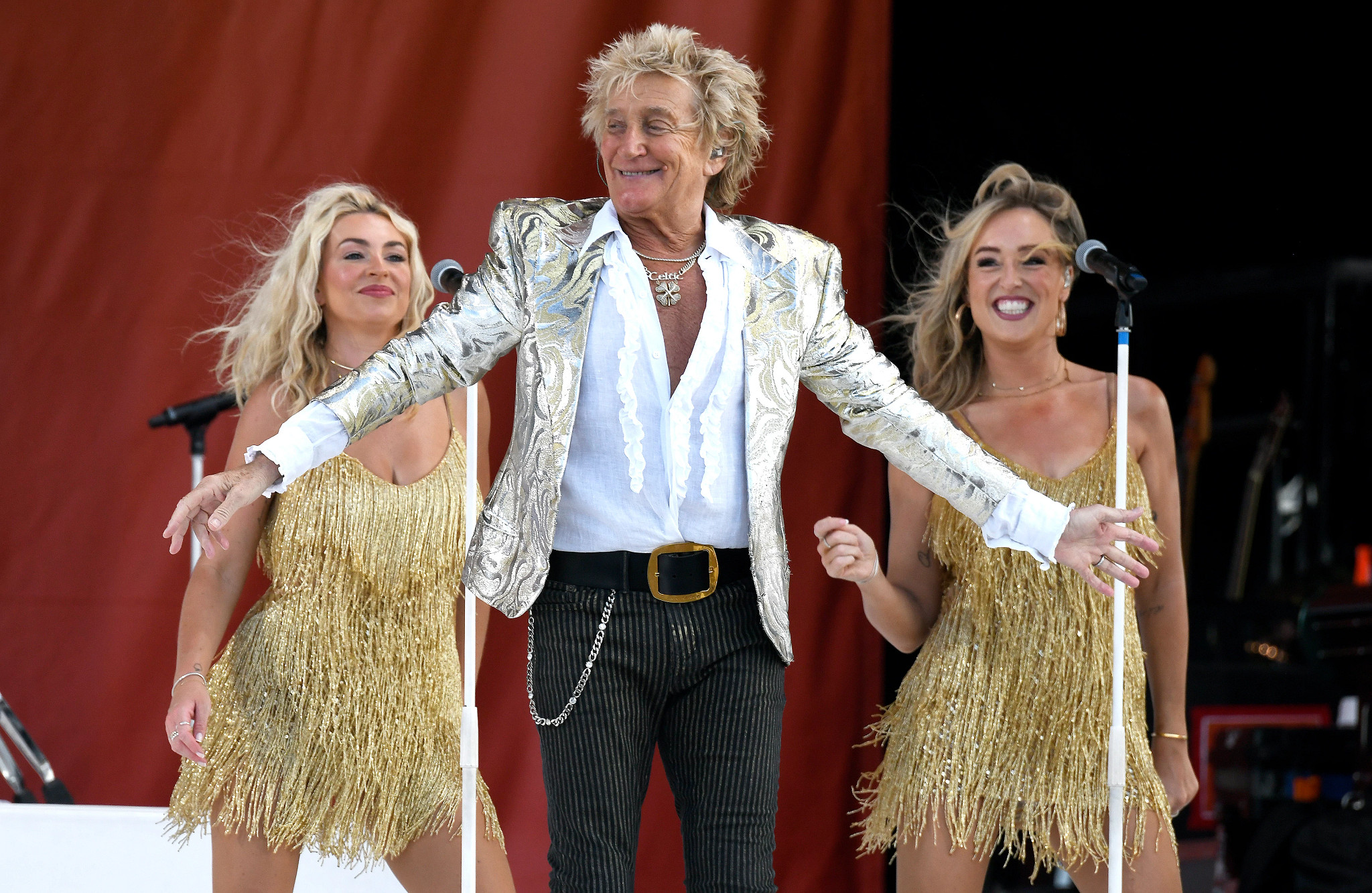 Rod Stewart performing with backup dancers.