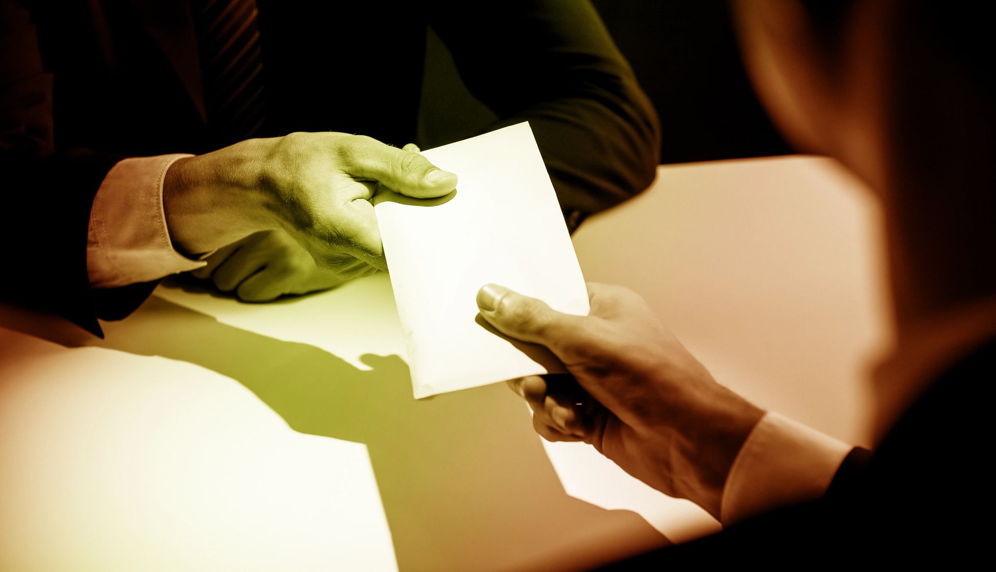 Medicare Drug Price Negotiation handing envelope over