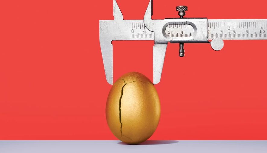 Rising Retirement Expenses a caliper measures the size of a golden egg, which has a crack in it