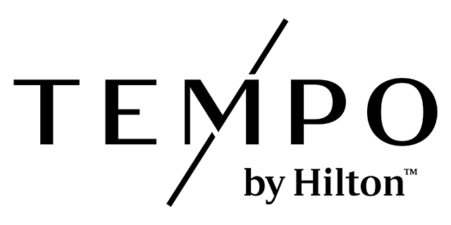 Tempo by Hilton logo in black letters on light gray background, diagonal line through the M in Tempo