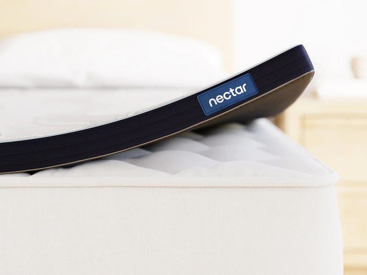 The Nectar Mattress Topper with Cooling Gel Memory Foam lifted off a mattress