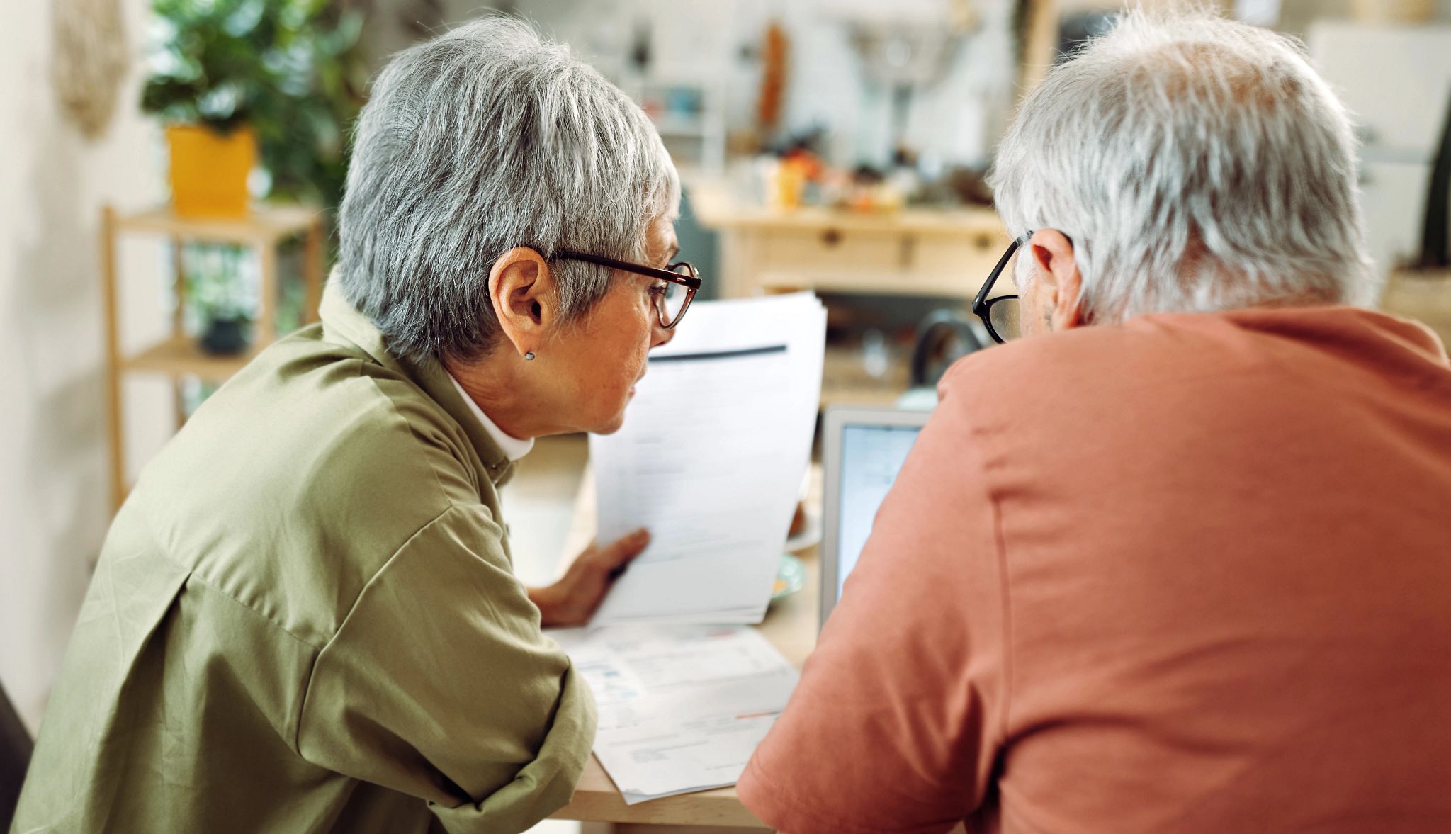 Senior couple going over bills at home