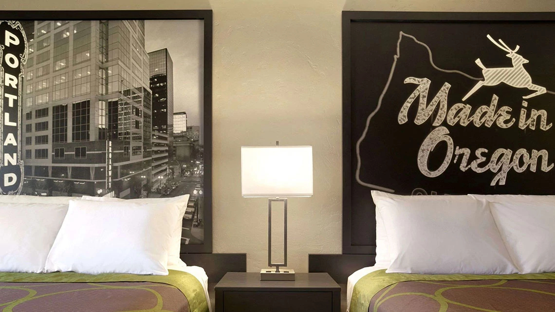 Super 8® by Wyndham Interior view of double beds and nightstand at Super 8 property