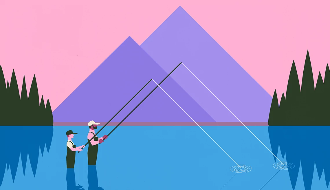 padre e hijo pescando cerca de una montaña