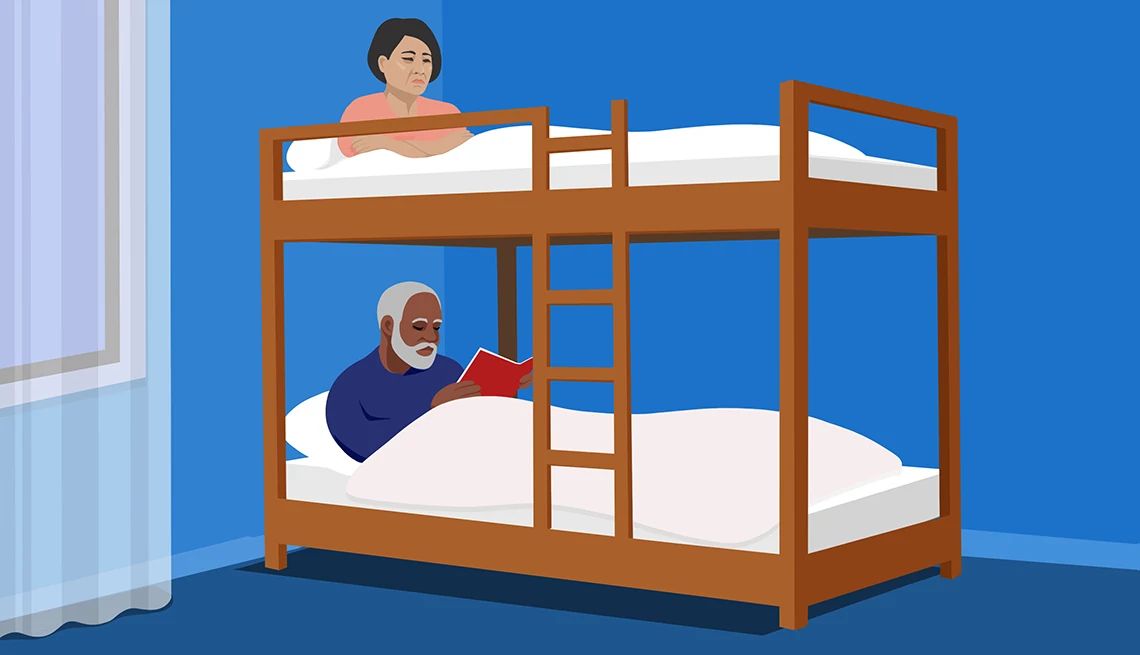 Married in a Bunkbed An illustration shows a man and a woman in bunkbeds in a blue bedroom with a window at the left. The man is in the bottom bunk reading a book while the woman is in the top bunk with her arms crossed.