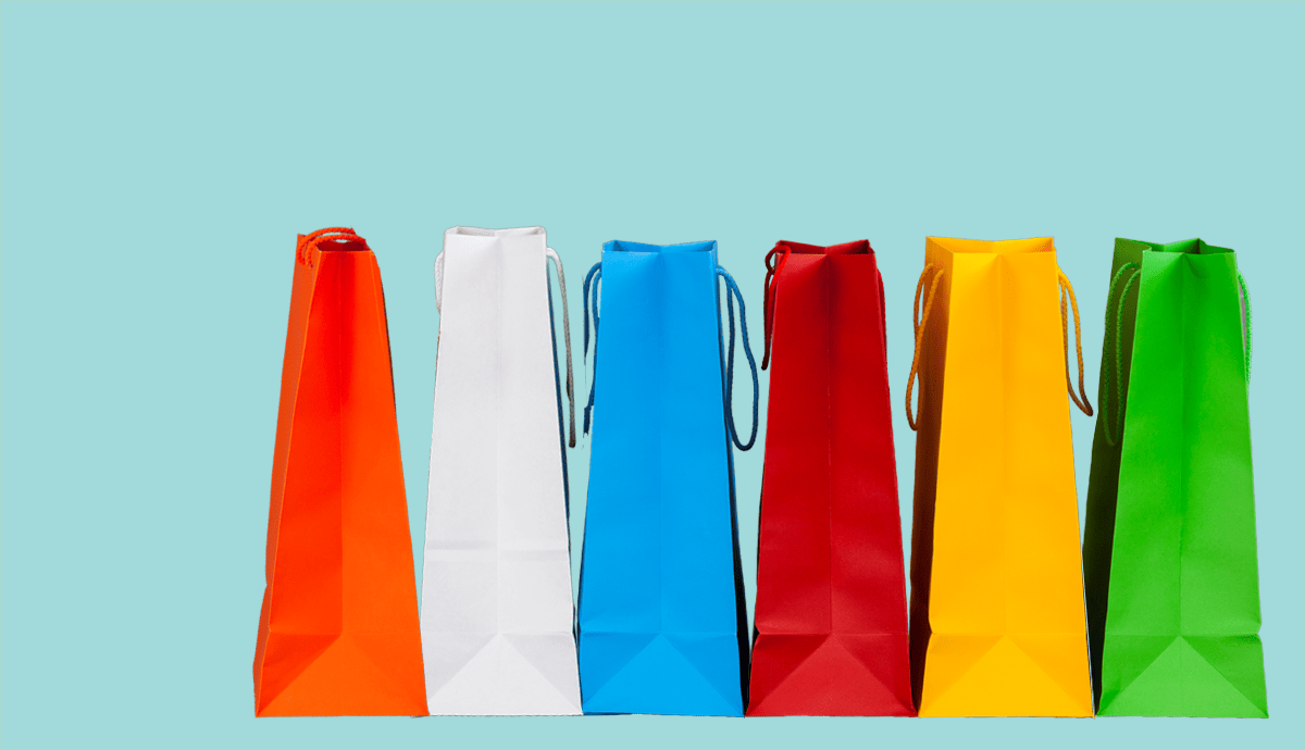 a wreaking ball knocks over different color shopping bags