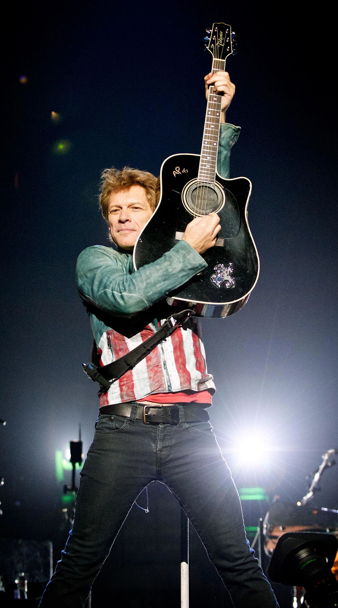 Jon Bon Jovi Jon Bon Jovi raises his guitar in the air during his performance at American Airlines Center in Dallas
