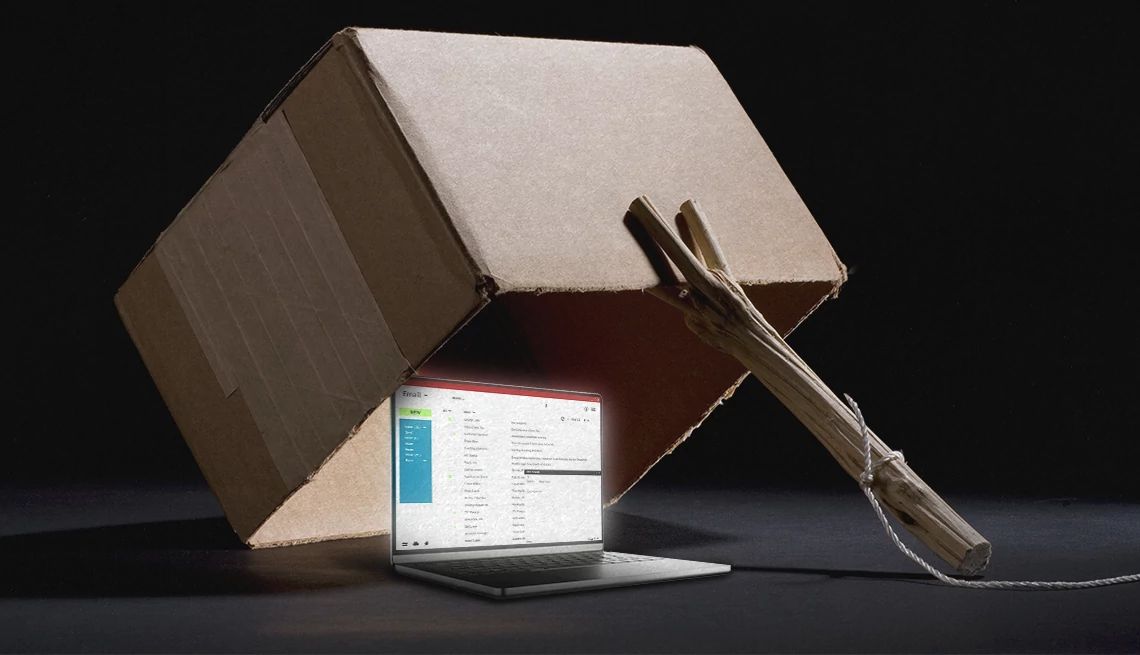 a box with a laptop underneath it with a stick and a string that looks like a trap