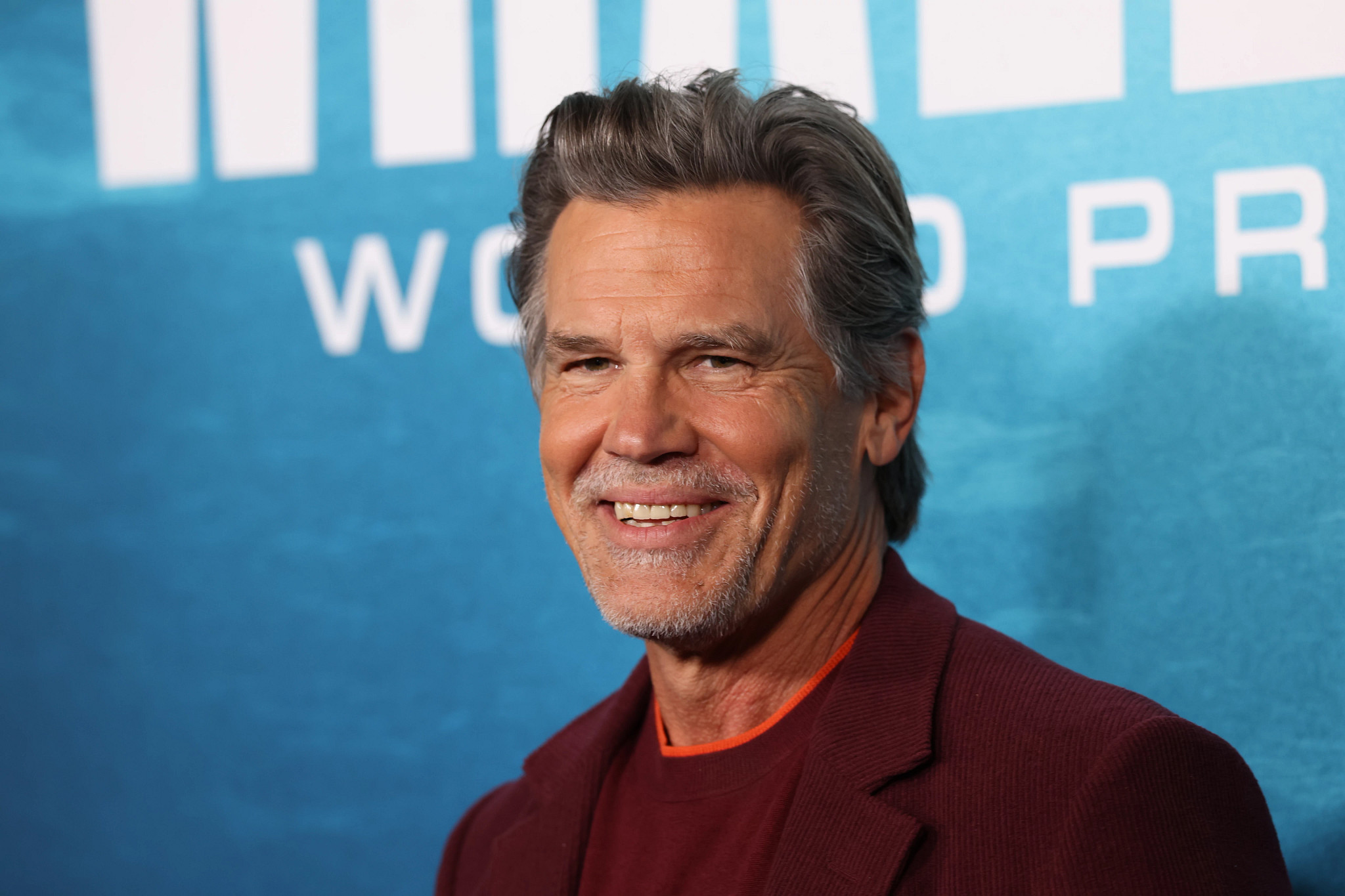 Josh Brolin smiling at an event.