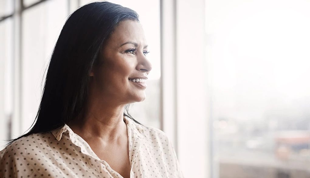 Women are more likely than men to have insomnia A woman looking out the window of a building