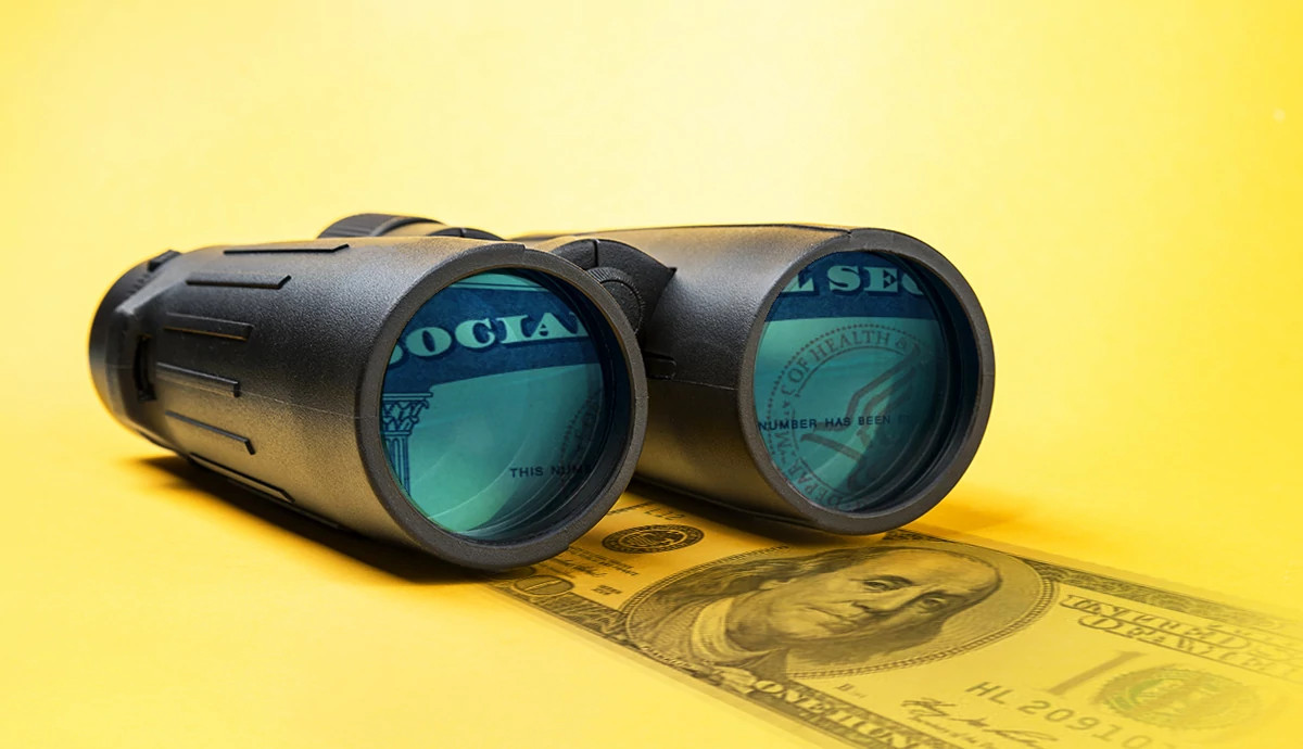 A graphic illustration of binoculars with the social security card logo in the frame
