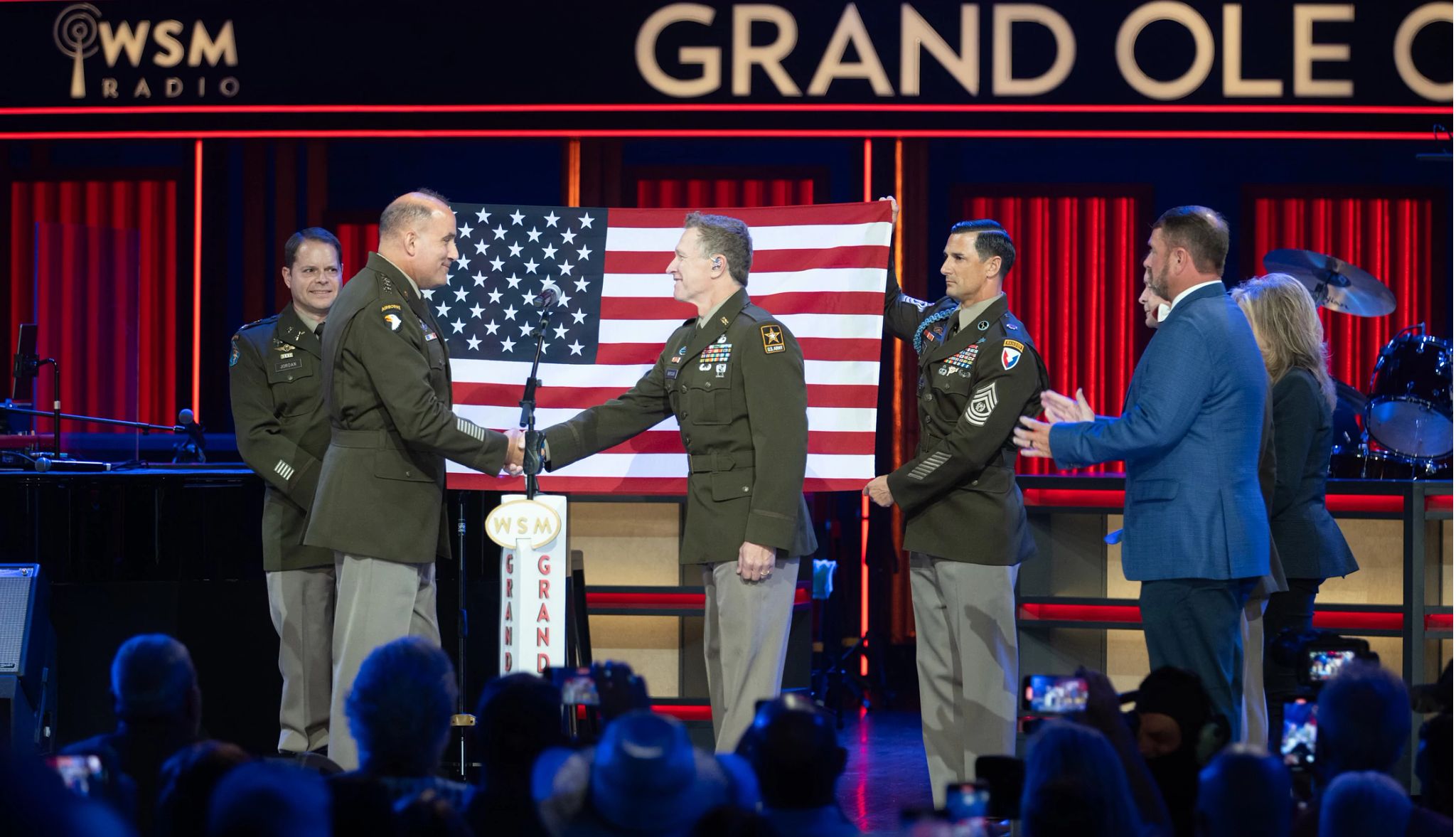 Craig Morgan was sworn into the U.S. Army Reserve at Nashville's Grand Ole Opry Craig Morgan on stage with Fort Campbell Garrison Commander Colonel Jordan; Commander, U.S. Army Forces Command General Poppas; Command Sergeant Major Stackpole; Deputy State Director/Military Adviser John Clement; Senator Marsha Blackburn with American flag behind them