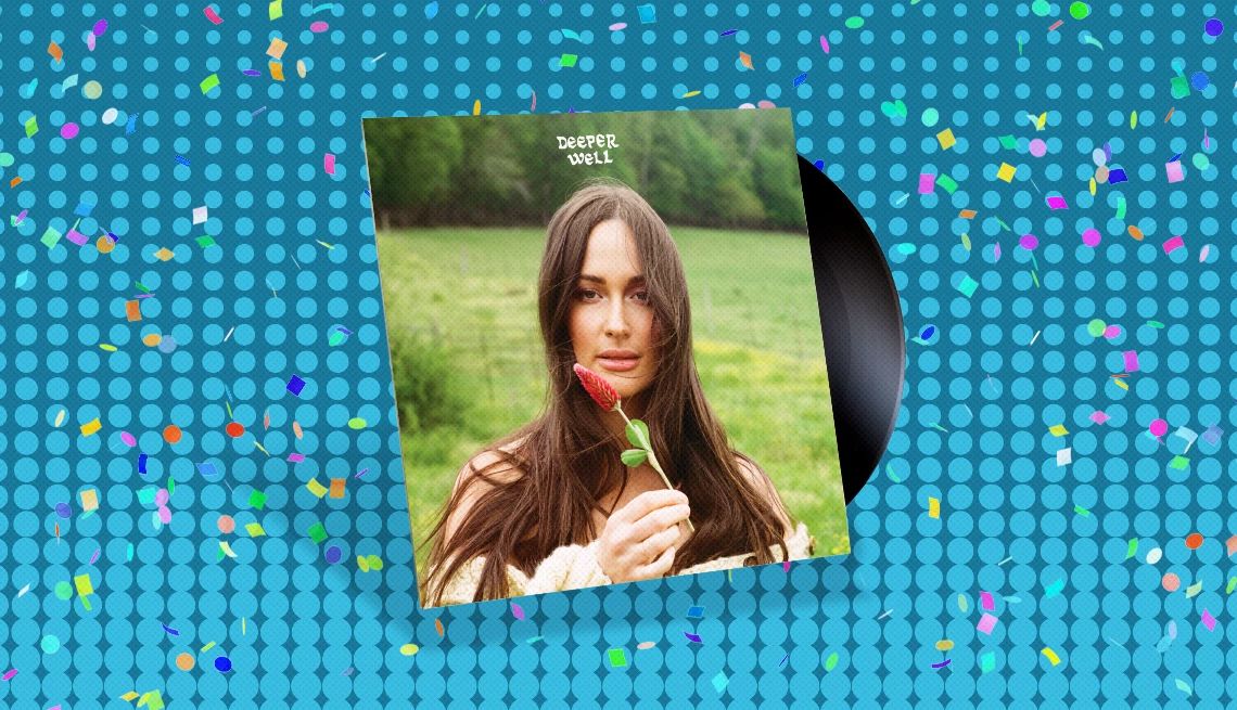 Kacey Musgraves' “Deeper Well” Album cover with record sticking out of it and the words Deeper Well with woman holding flower on cover; blue background with confetti on it