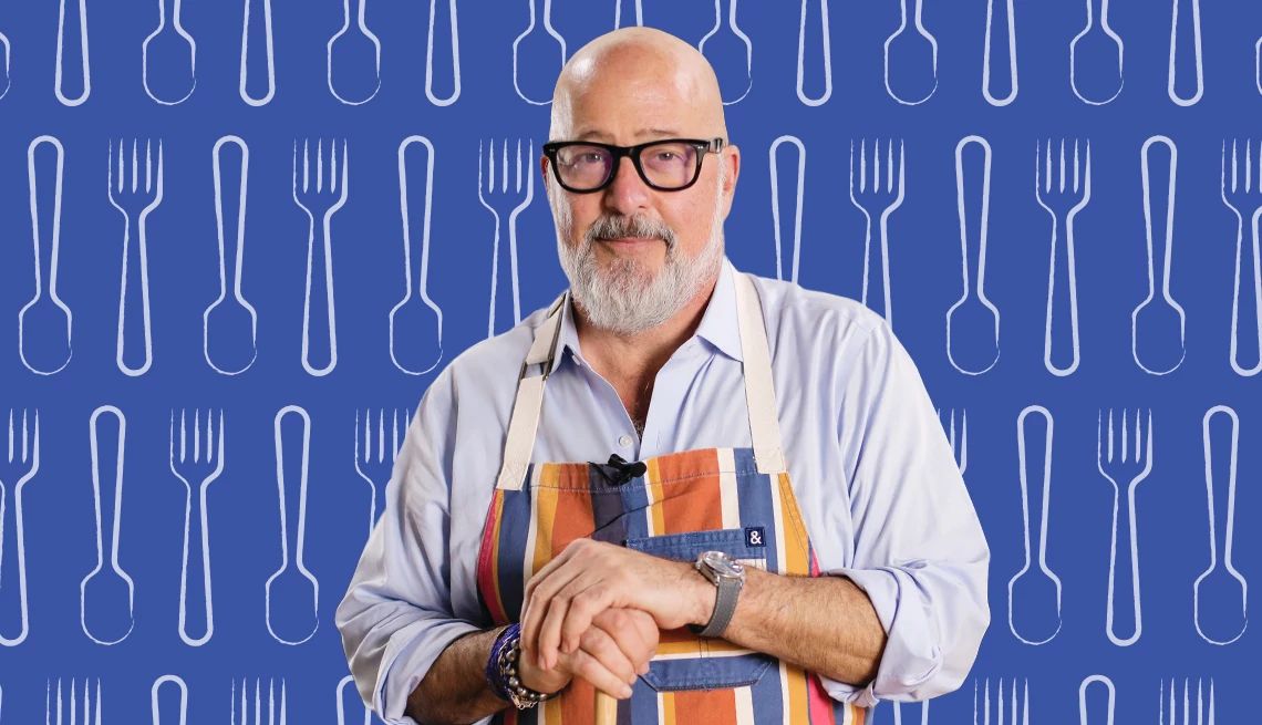 Andrew Zimmern Seafood Cookbook chef Andrew Zimmern is shown in photo in front of a culinary themed backdrop
