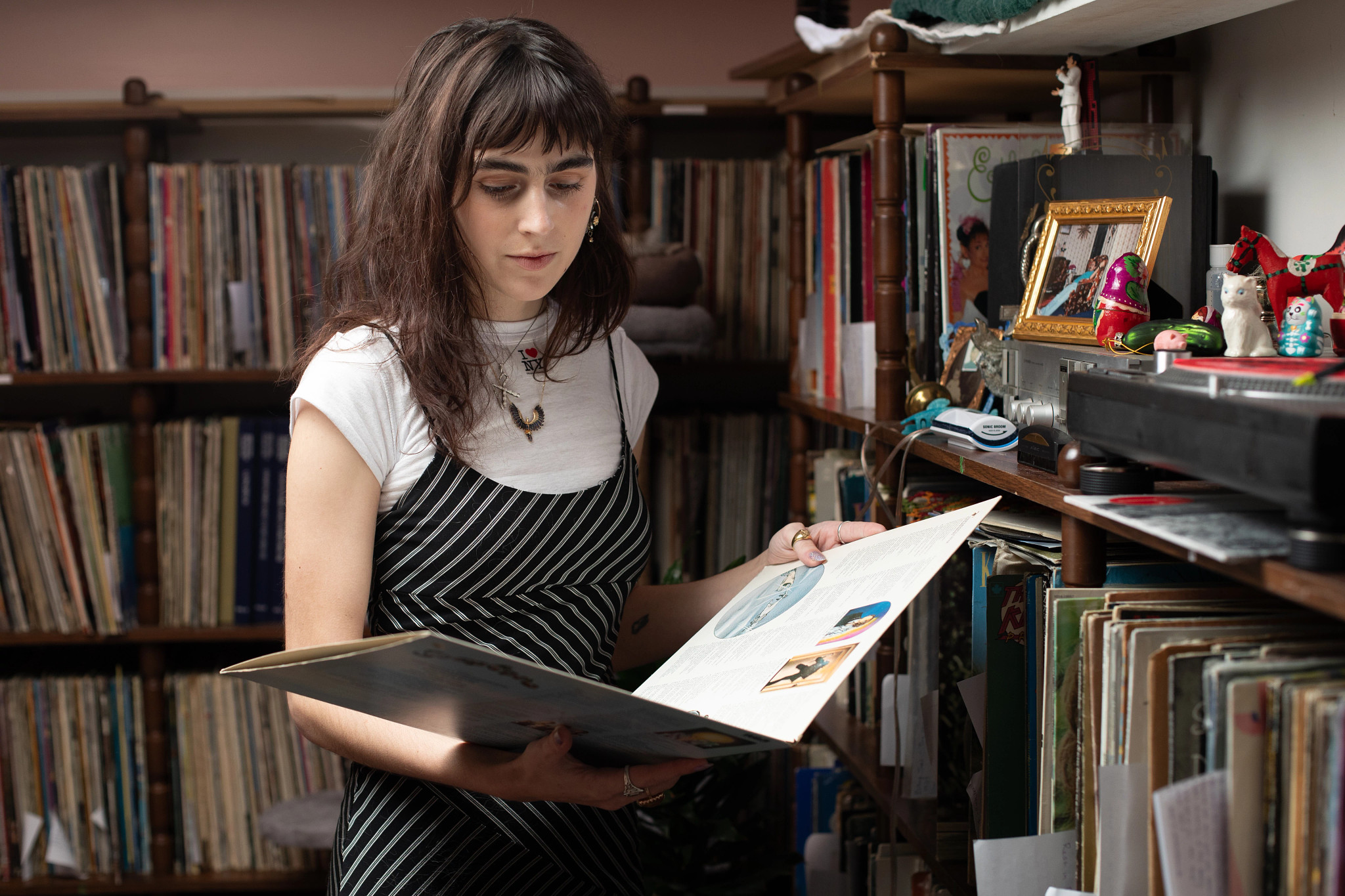 a woman looks at a record