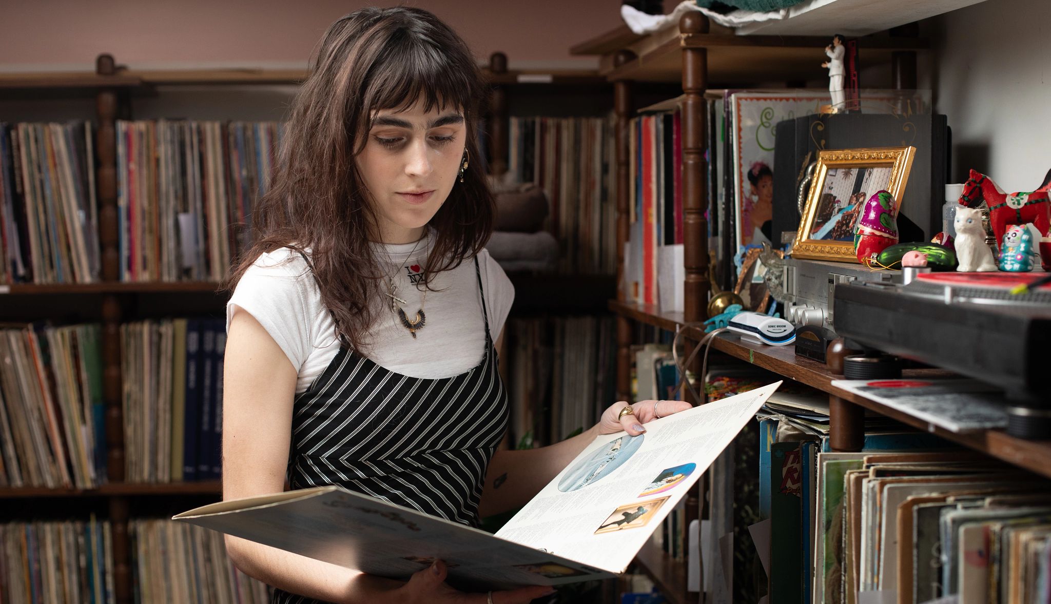 My Dad Lives On, Through the Record Albums He Left Behind a woman looks at a record