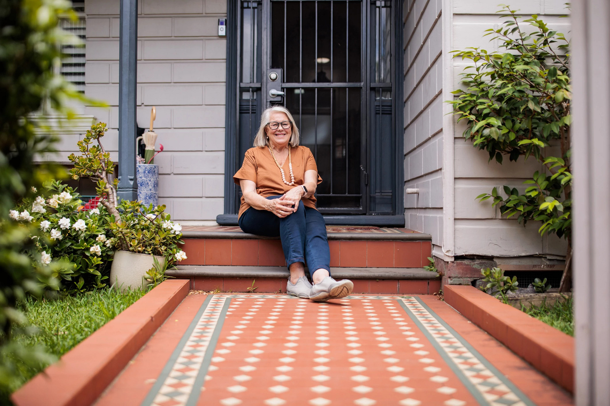 Women sitting in front of a house