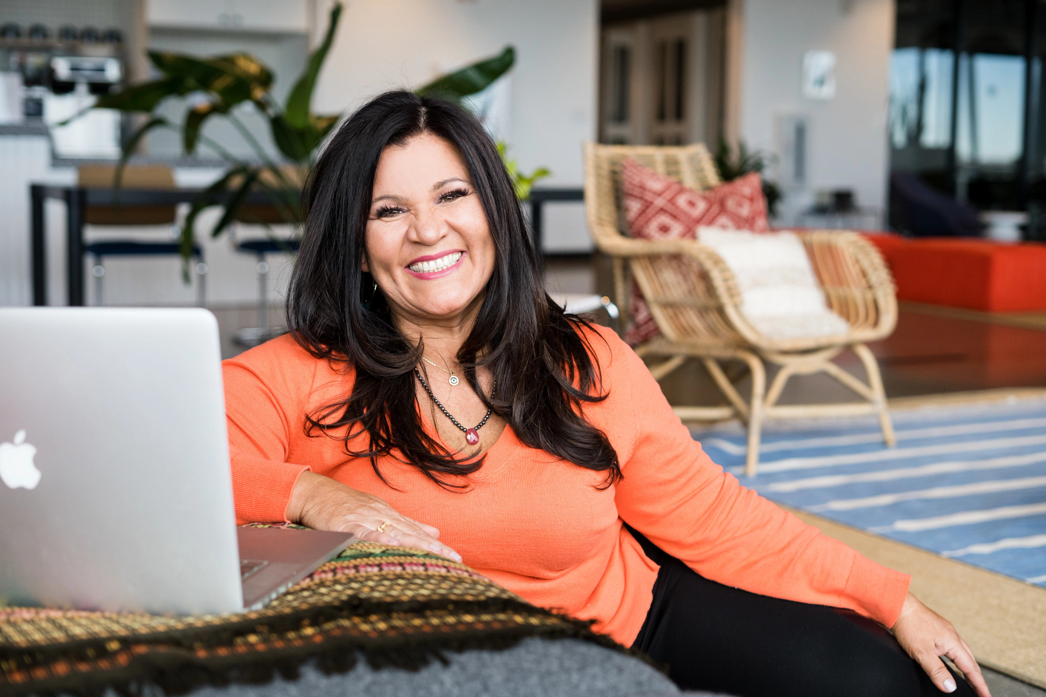 Denise Soler Cox is shown in a photo sitting next to her laptop
