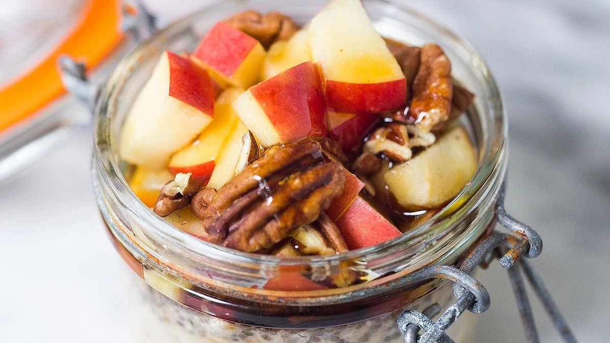 A close-up view of apple-cinnamon overnight oats in a glass