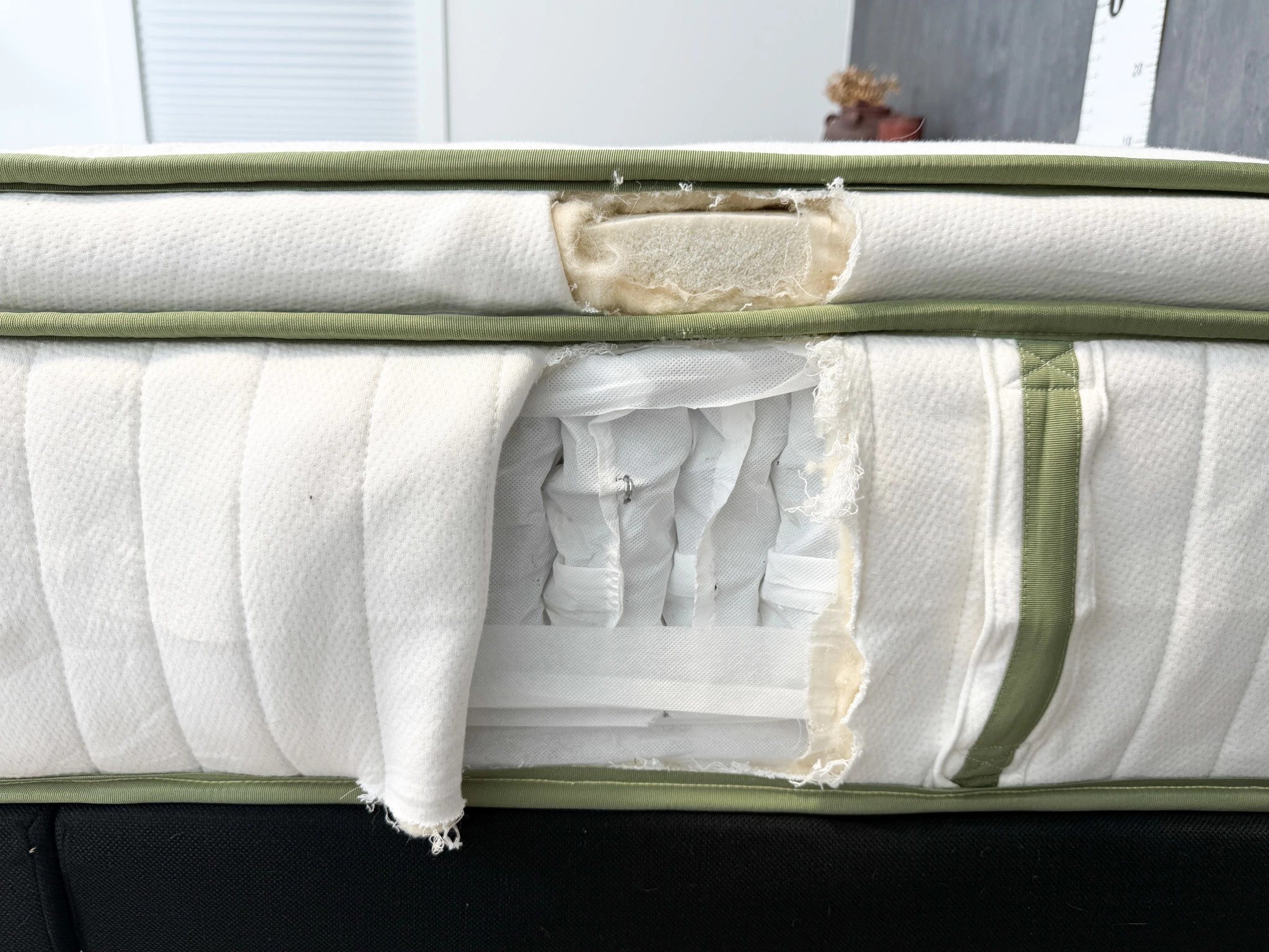 A cut-out section of the Silk & Snow Organic mattress showing the foam and spring materials inside.