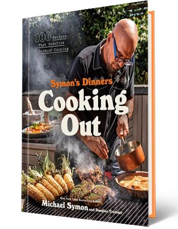 Chef Michael Symon Shares Recipes From His New Cookbook the cover of michael symon's new cookbook "symon's dinners cooking out: 100 recipes that redefine outdoor cooking"