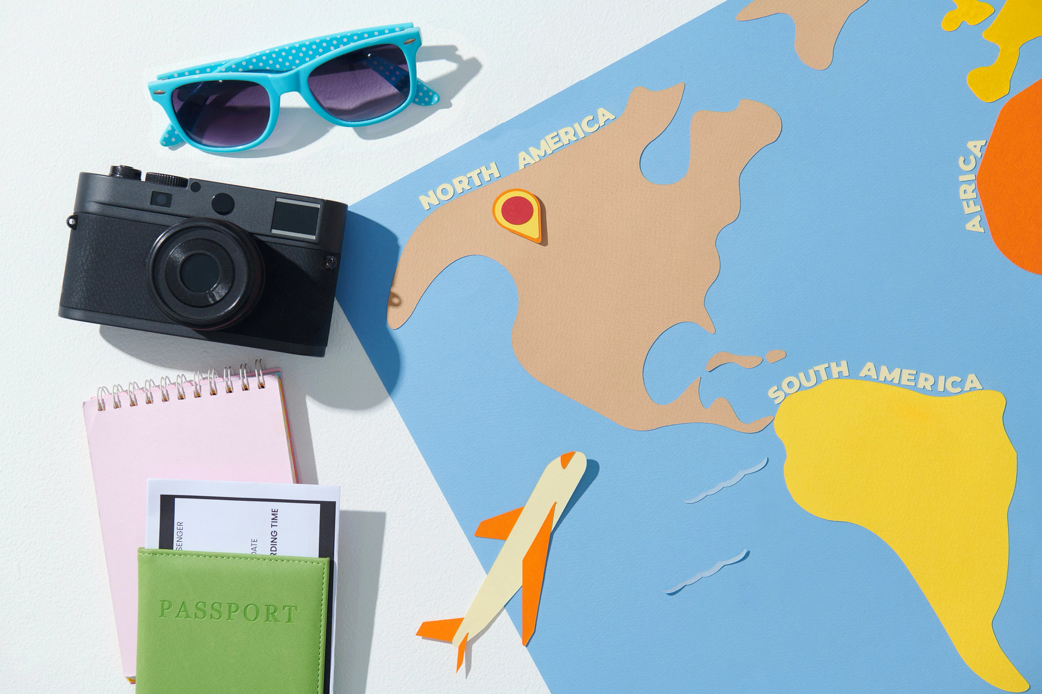 a map with a camera, plane and various other travel icons around it