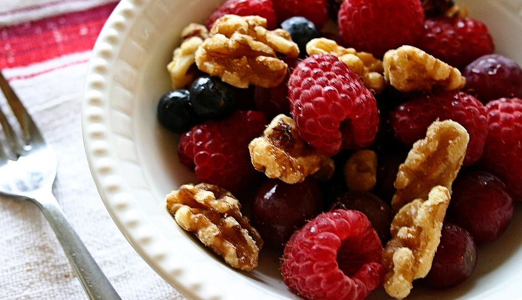Walnuts are packed with healthy omega-3s A close-up view of berries and walnuts in a bowl