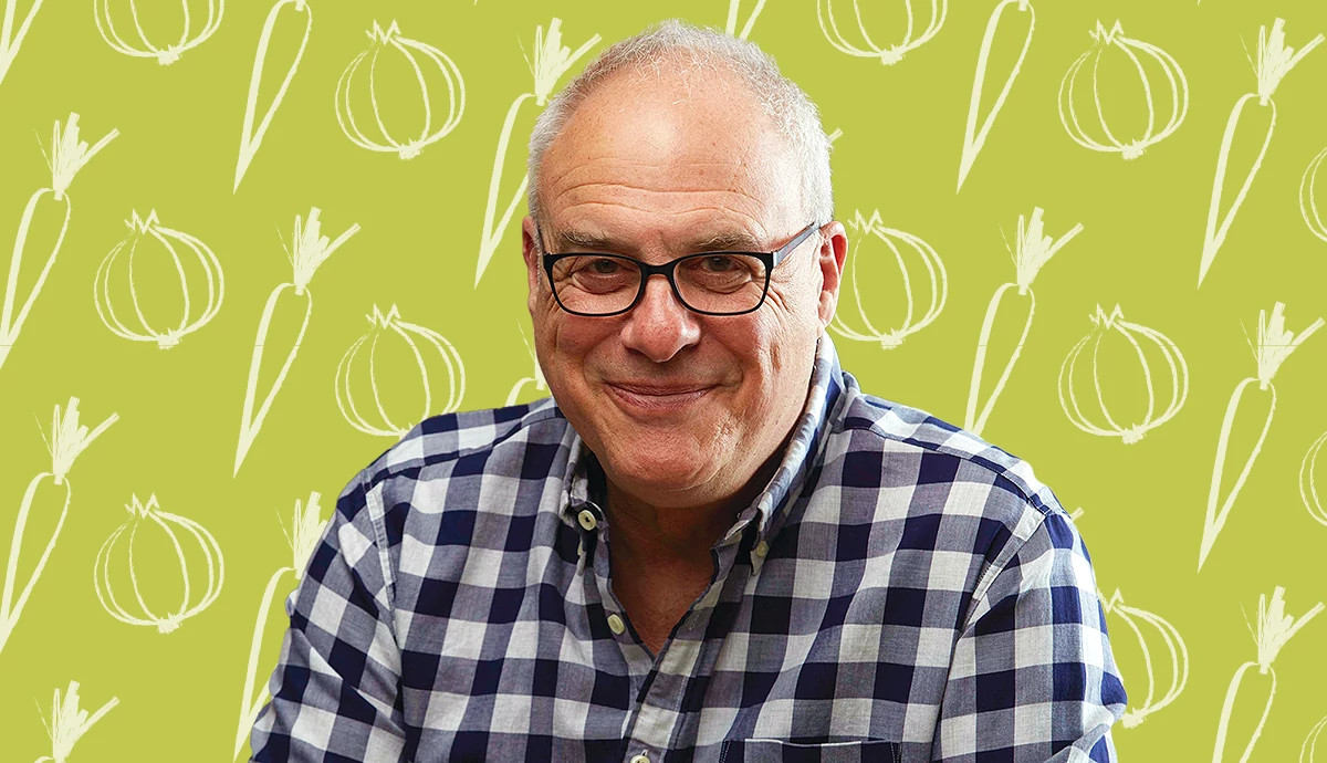 Chef Mark Bittman in front of a food-themed backdrop