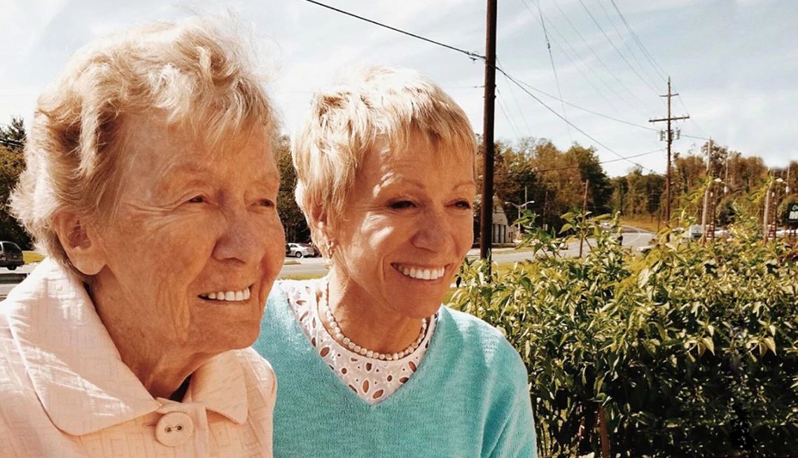 Barbara Corcoran and her mother smile while looking off in the distance
