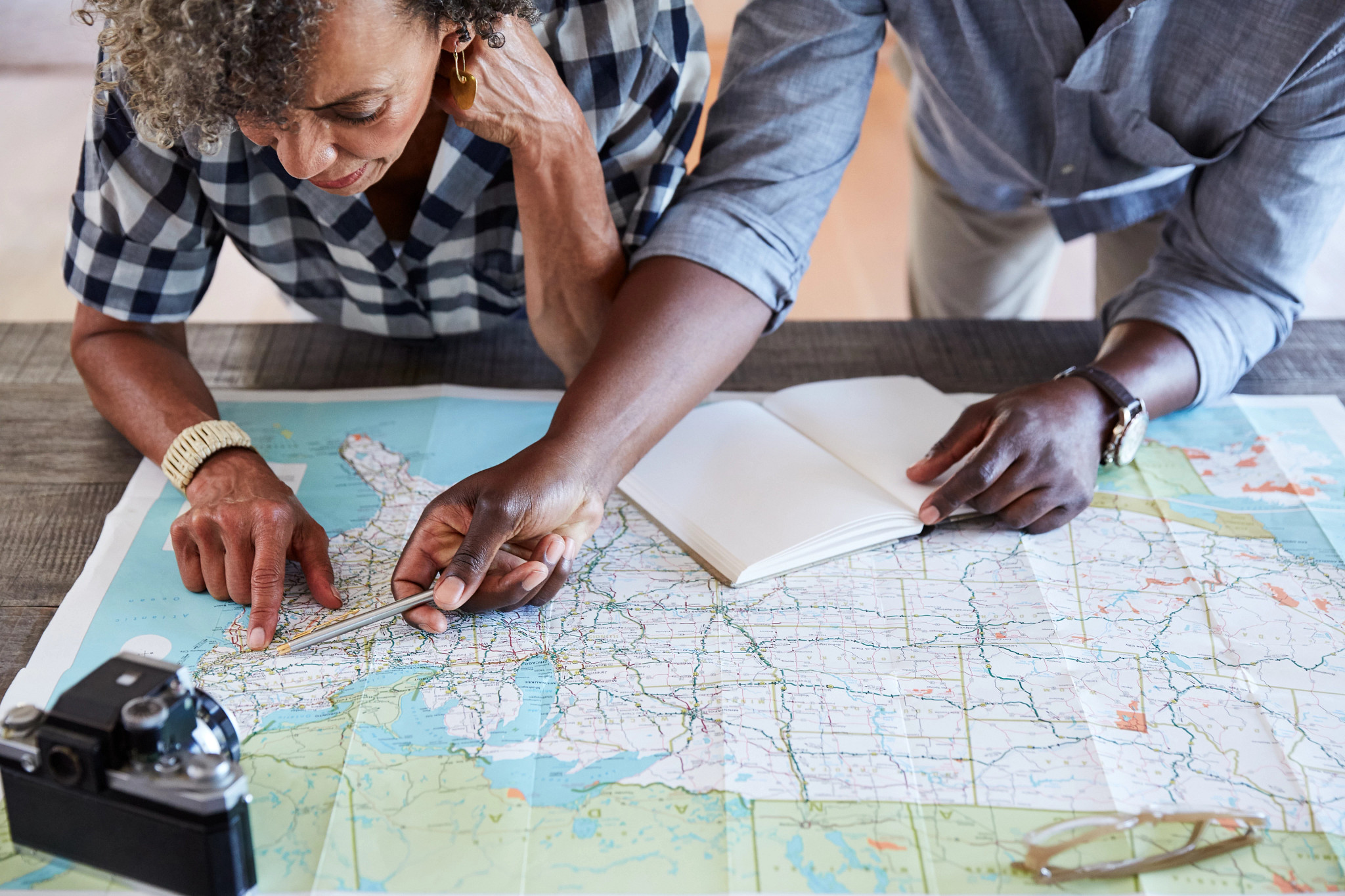 two people looking at a map on a table