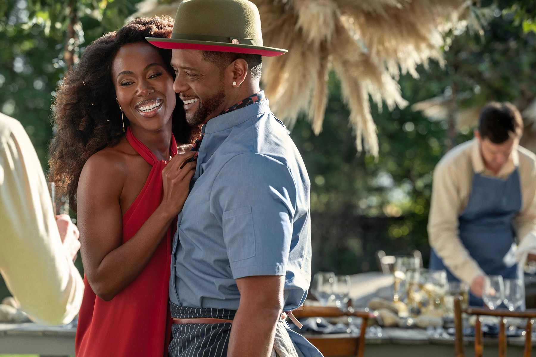 DeWanda Wise leaning against Blair Underwood, both smiling, in a still from Three Women