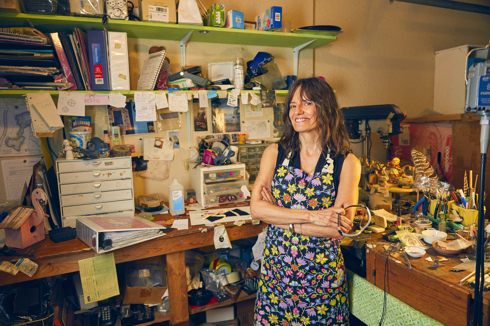 a woman posing at her jewelry-making studio