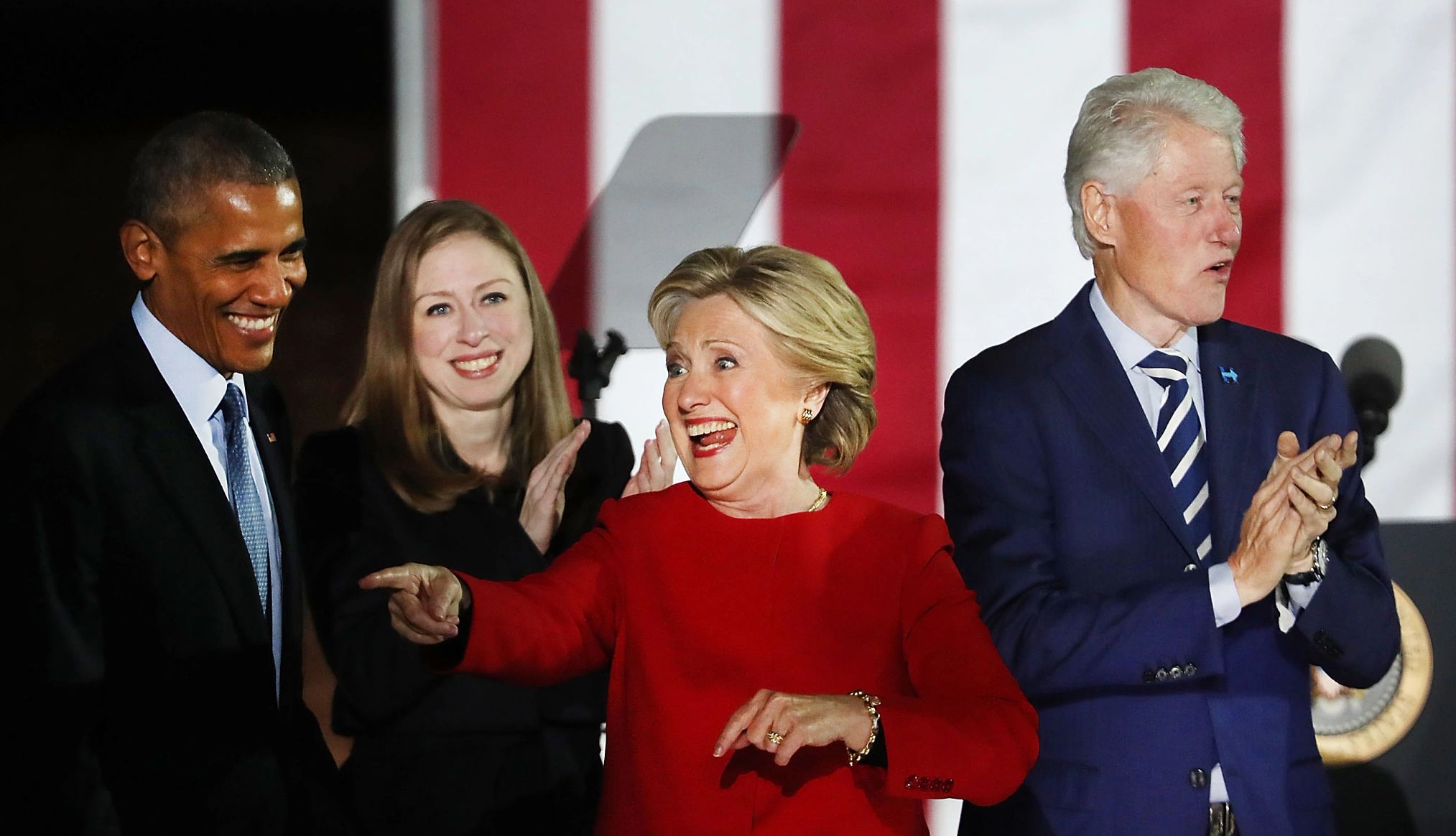 Hillary Clinton, Barack Obama, Bill Clinton, Chelsea Clinton hillary clinton points off stage while barack obama, chelsea clinton and bill clinton stand behind her