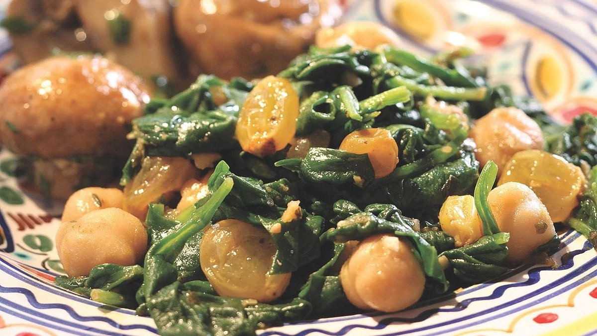 A close-up view of spinach with chickpeas on a plate