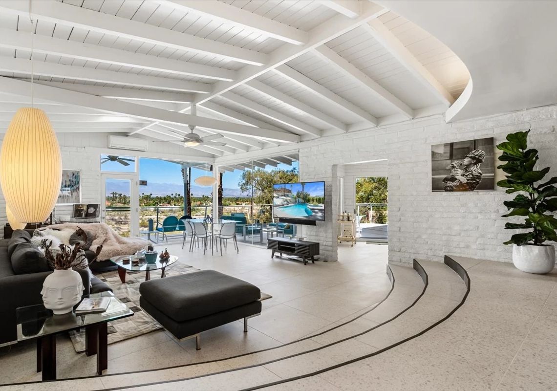 Howard Hughes home a living room with furniture and floor to ceiling windows