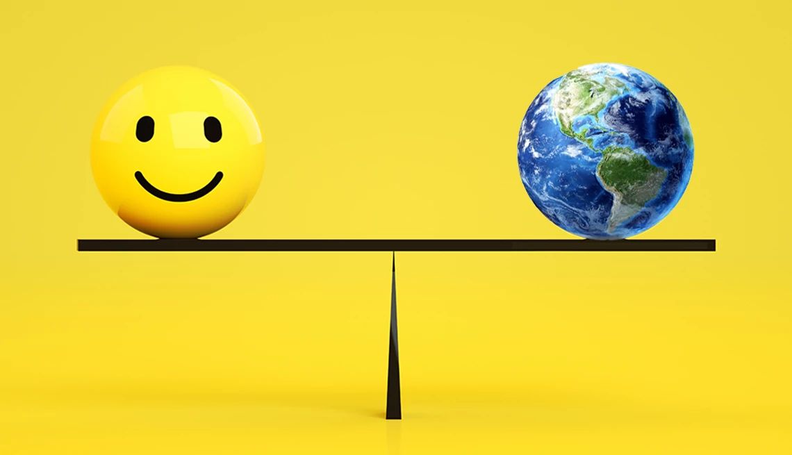 a level scale with a smiley face on one end and the world on the other side
