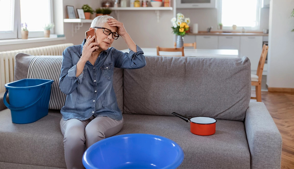 Woman sitting on couch and talking on phone. 