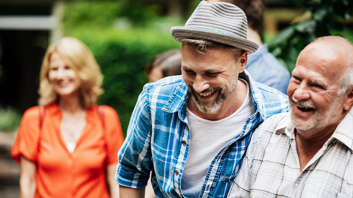 grandfather, son, mom in background, smiling, talking, walking outside