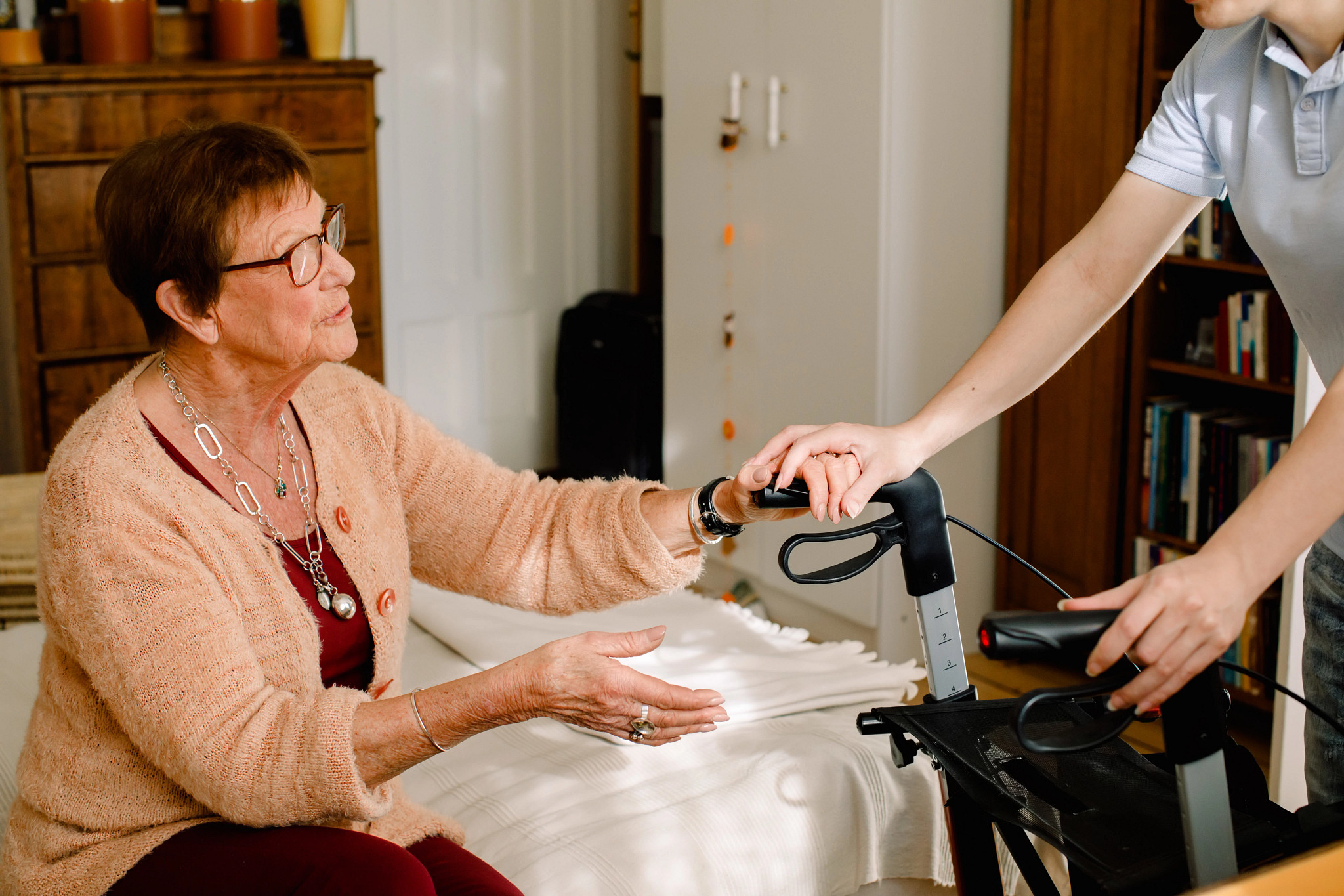 a person being helped to a walker
