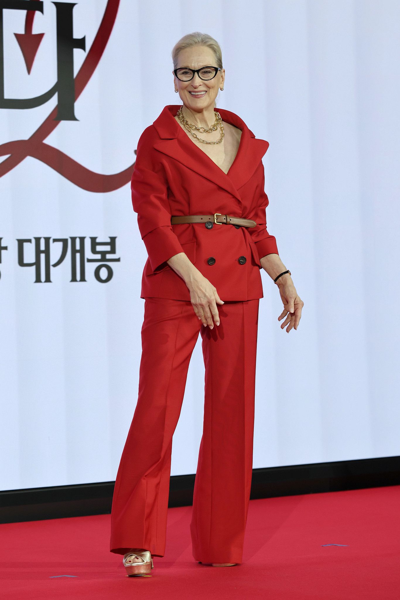 Streep wears a custom red Prada double-breasted suit 