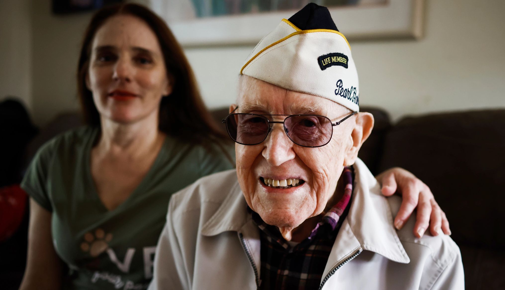 Oldest Pearl Harbor attack survivor dies at 105 an older veteran smiles while his daughter sits next to him
