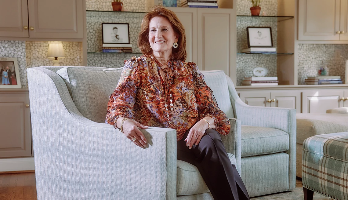 Author Anita McBride sitting on a chair in a living room Author Anita McBride sitting on a chair in a living room