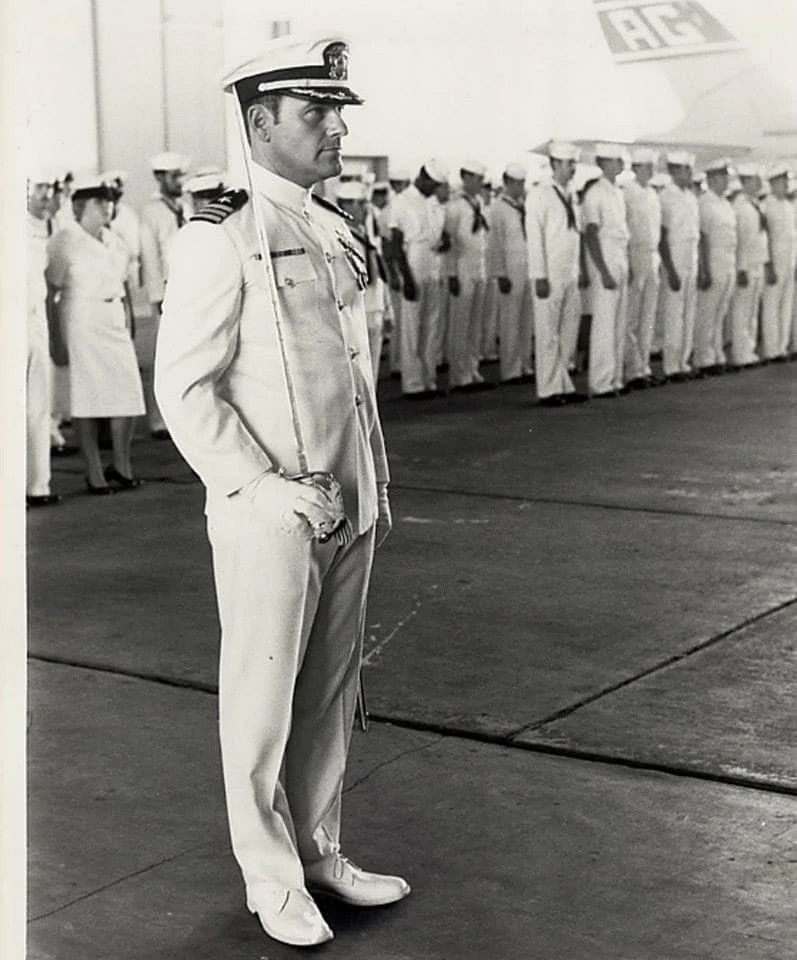 The author’s father-in-law, Jim Lichtenwalter, is shown in a black and white photo, wearing his dress whites and holding a saber