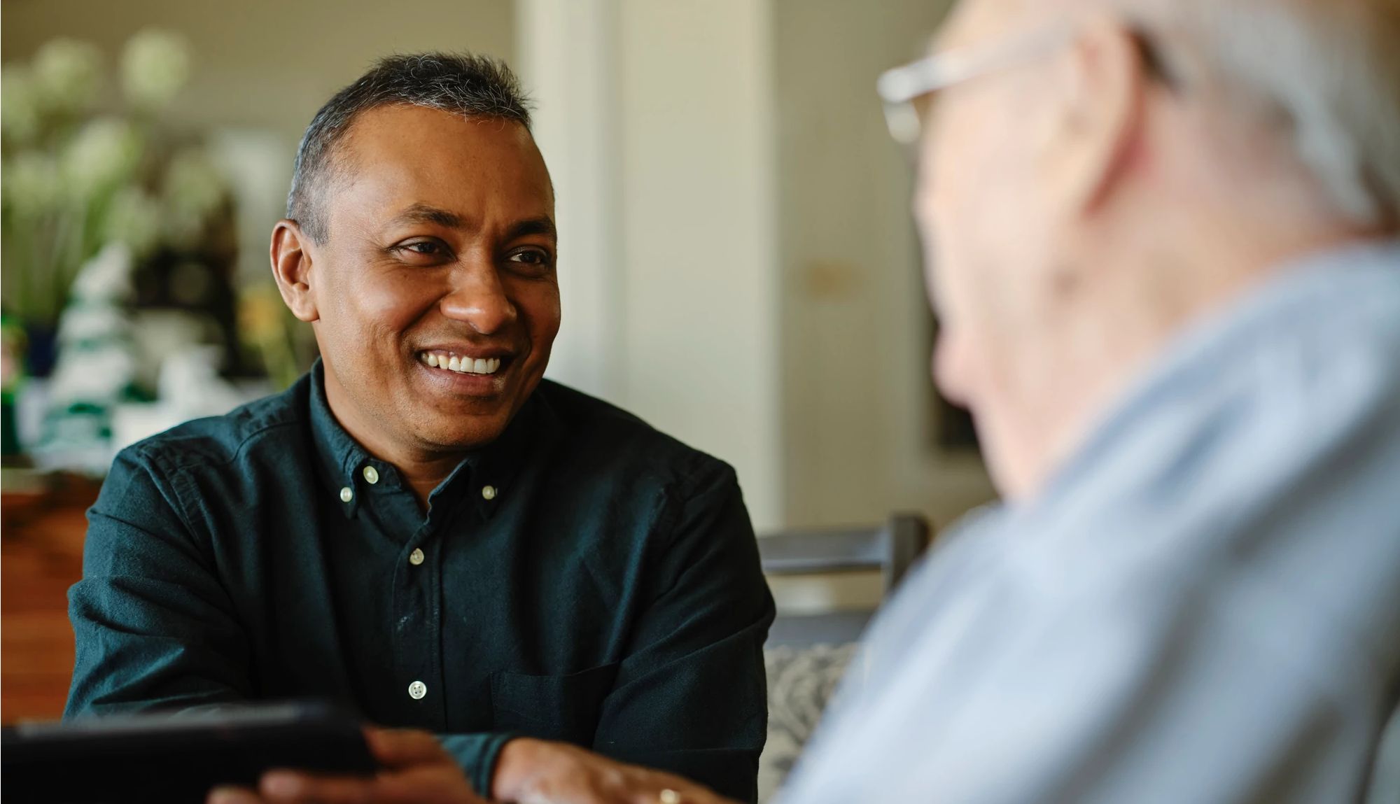 How Geriatric Care Managers Can Help Caregivers A health care worker attending to a senior citizen resident in a senior care living facility