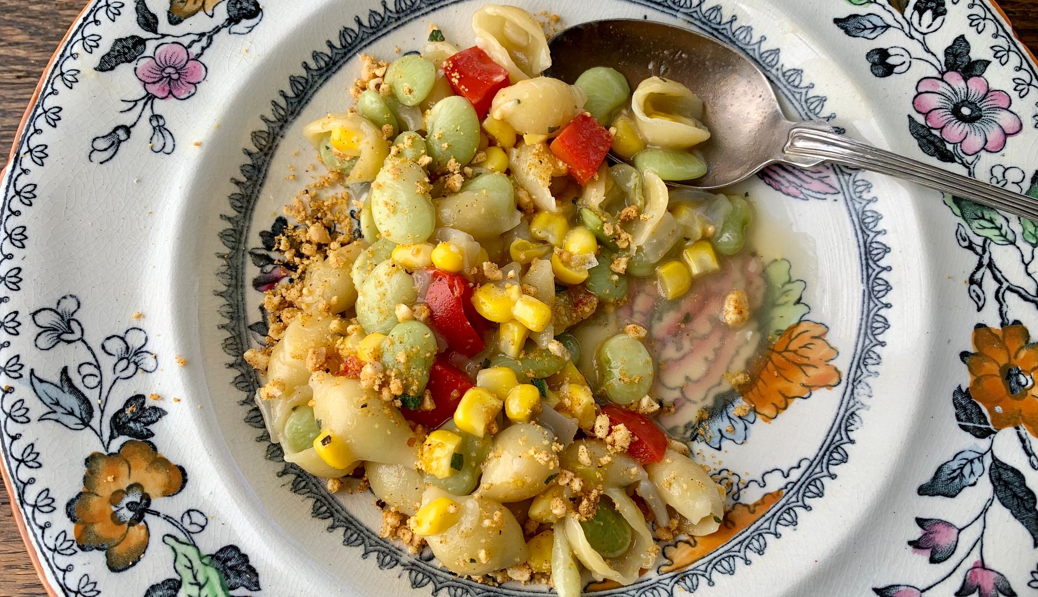Succotash and Shells Succotash and Shells with lima beans, corn and cut up red bell peppers in dish with spoon in it