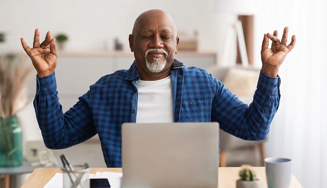 a man having a zen moment in front of his computer