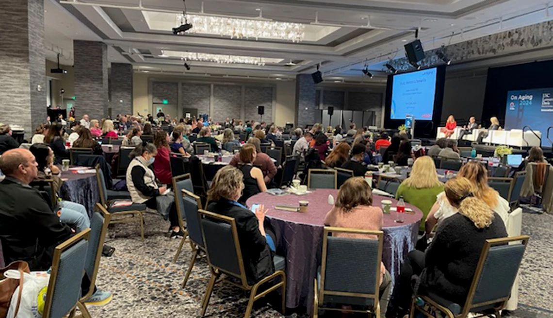 The Brain Health Action Collaborative is hosting an in-person gathering during the Gerontological Society of America (GSA) conference A conference room filled with people sitting at round tables
